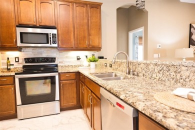 Stunning 4-Bedroom Pool Home with Office  Bonus Room in Gated on Heritage Isles Golf and Country Club in Florida - for sale on GolfHomes.com, golf home, golf lot