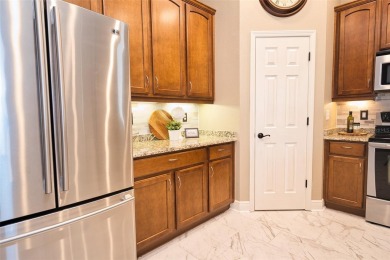Stunning 4-Bedroom Pool Home with Office  Bonus Room in Gated on Heritage Isles Golf and Country Club in Florida - for sale on GolfHomes.com, golf home, golf lot