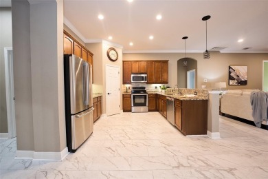 Stunning 4-Bedroom Pool Home with Office  Bonus Room in Gated on Heritage Isles Golf and Country Club in Florida - for sale on GolfHomes.com, golf home, golf lot