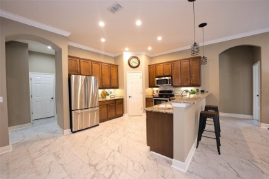 Stunning 4-Bedroom Pool Home with Office  Bonus Room in Gated on Heritage Isles Golf and Country Club in Florida - for sale on GolfHomes.com, golf home, golf lot