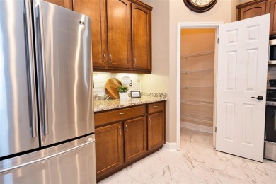 Stunning 4-Bedroom Pool Home with Office  Bonus Room in Gated on Heritage Isles Golf and Country Club in Florida - for sale on GolfHomes.com, golf home, golf lot