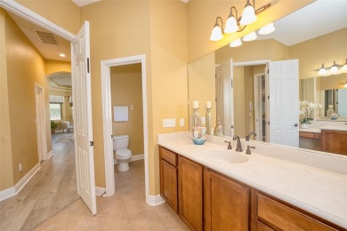 Stunning 4-Bedroom Pool Home with Office  Bonus Room in Gated on Heritage Isles Golf and Country Club in Florida - for sale on GolfHomes.com, golf home, golf lot