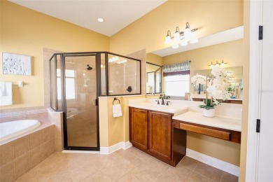 Stunning 4-Bedroom Pool Home with Office  Bonus Room in Gated on Heritage Isles Golf and Country Club in Florida - for sale on GolfHomes.com, golf home, golf lot