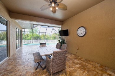 Stunning 4-Bedroom Pool Home with Office  Bonus Room in Gated on Heritage Isles Golf and Country Club in Florida - for sale on GolfHomes.com, golf home, golf lot