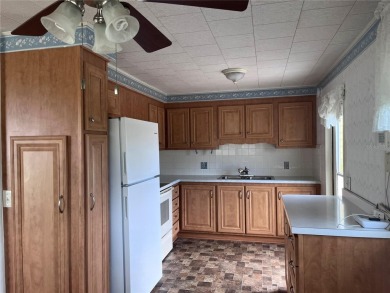 Come see this cheery yellow home, and enjoy sunny Florida living on Heather Hills Golf Course in Florida - for sale on GolfHomes.com, golf home, golf lot