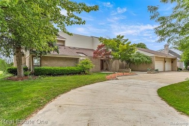 Experience refined contemporary living in this exquisite on Riverview Highlands Golf Club  in Michigan - for sale on GolfHomes.com, golf home, golf lot