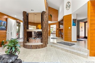 Experience refined contemporary living in this exquisite on Riverview Highlands Golf Club  in Michigan - for sale on GolfHomes.com, golf home, golf lot