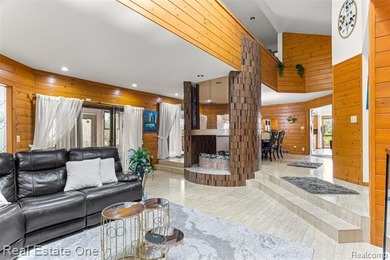 Experience refined contemporary living in this exquisite on Riverview Highlands Golf Club  in Michigan - for sale on GolfHomes.com, golf home, golf lot