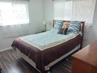 Fall in love with this 2Br/2Ba corner villa is ideally located on Leisureville Community Golf Course in Florida - for sale on GolfHomes.com, golf home, golf lot