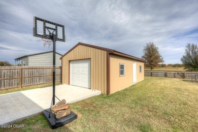 GOLF COURSE VIEW!  Enjoy this inviting 4-bedroom, 2-bath home on Neosho Municipal Golf Course in Missouri - for sale on GolfHomes.com, golf home, golf lot