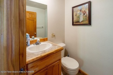 Escape to your own hand-hewn log retreat nestled in the woods of on Star Valley RV Golf Course in Wyoming - for sale on GolfHomes.com, golf home, golf lot