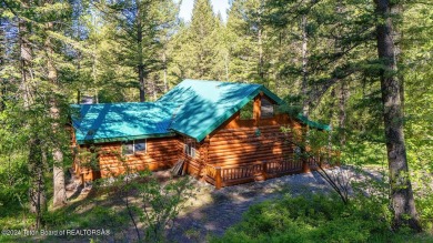 Escape to your own hand-hewn log retreat nestled in the woods of on Star Valley RV Golf Course in Wyoming - for sale on GolfHomes.com, golf home, golf lot