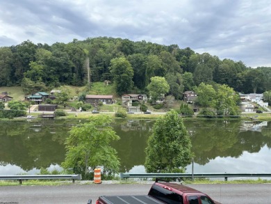 Enjoy the scenic waterfront view from your living room window on Lake Floyd Golf Club, Inc. in West Virginia - for sale on GolfHomes.com, golf home, golf lot