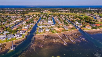 Enjoy the Gulf Breeze lifestyle in this waterfront home with on Tiger Point Golf and Country Club in Florida - for sale on GolfHomes.com, golf home, golf lot