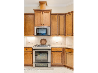 This elegant all-brick, one-level home is perfectly situated in on Reserve Club At St James Plantation in North Carolina - for sale on GolfHomes.com, golf home, golf lot