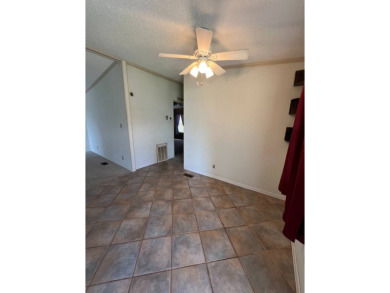 2 bed | 2 bath | 864 sq ft - Handyman's Special in Highly on Lake Henry Golf Club in Florida - for sale on GolfHomes.com, golf home, golf lot