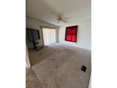 2 bed | 2 bath | 864 sq ft - Handyman's Special in Highly on Lake Henry Golf Club in Florida - for sale on GolfHomes.com, golf home, golf lot