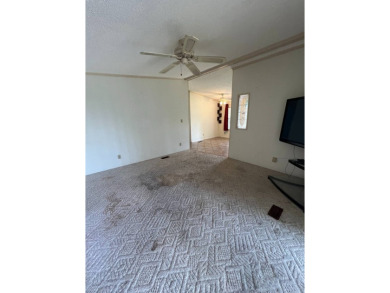 2 bed | 2 bath | 864 sq ft - Handyman's Special in Highly on Lake Henry Golf Club in Florida - for sale on GolfHomes.com, golf home, golf lot
