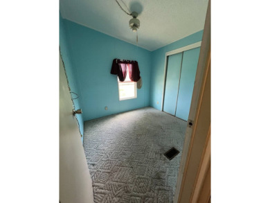 2 bed | 2 bath | 864 sq ft - Handyman's Special in Highly on Lake Henry Golf Club in Florida - for sale on GolfHomes.com, golf home, golf lot