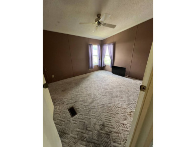 2 bed | 2 bath | 864 sq ft - Handyman's Special in Highly on Lake Henry Golf Club in Florida - for sale on GolfHomes.com, golf home, golf lot