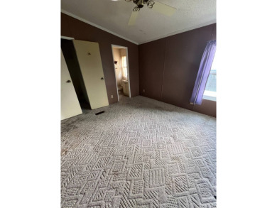 2 bed | 2 bath | 864 sq ft - Handyman's Special in Highly on Lake Henry Golf Club in Florida - for sale on GolfHomes.com, golf home, golf lot