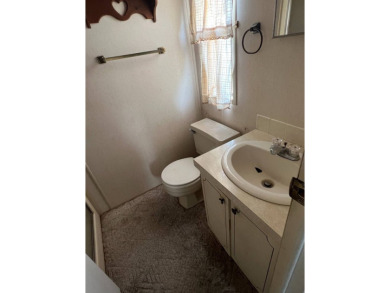2 bed | 2 bath | 864 sq ft - Handyman's Special in Highly on Lake Henry Golf Club in Florida - for sale on GolfHomes.com, golf home, golf lot