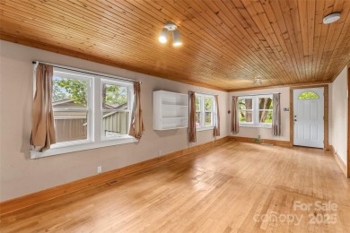 Views of Lake Tomahawk! This charming 2-bedroom/1-bath cottage on Black Mountain Golf Course in North Carolina - for sale on GolfHomes.com, golf home, golf lot