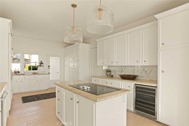 As waves break along Salt Creek Beach, evening lights shimmer on Monarch Beach Golf Links in California - for sale on GolfHomes.com, golf home, golf lot