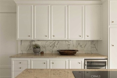 As waves break along Salt Creek Beach, evening lights shimmer on Monarch Beach Golf Links in California - for sale on GolfHomes.com, golf home, golf lot