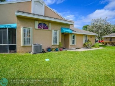 Welcome to this beautiful end unit located on the 5th green of on Woodmont Country Club in Florida - for sale on GolfHomes.com, golf home, golf lot