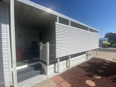 This cozy, bright park model home features a huge covered deck on Juniper Ridge R.V. Golf Resort in Arizona - for sale on GolfHomes.com, golf home, golf lot