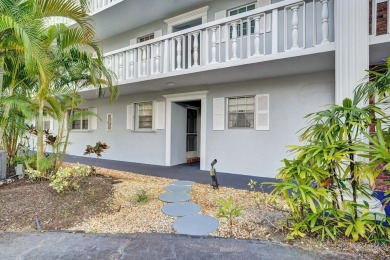 GROUND LEVEL CONDO WITH STUNNING LAKE & GOLF VIEWS Discover on Atlantis Golf Club in Florida - for sale on GolfHomes.com, golf home, golf lot