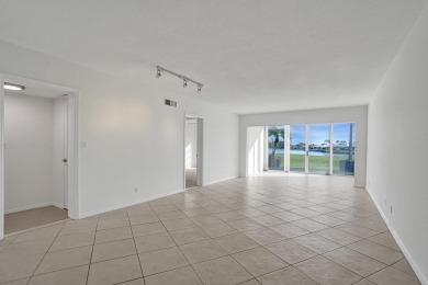GROUND LEVEL CONDO WITH STUNNING LAKE & GOLF VIEWS Discover on Atlantis Golf Club in Florida - for sale on GolfHomes.com, golf home, golf lot