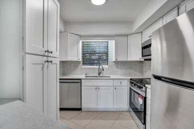 GROUND LEVEL CONDO WITH STUNNING LAKE & GOLF VIEWS Discover on Atlantis Golf Club in Florida - for sale on GolfHomes.com, golf home, golf lot