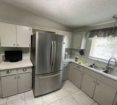 This lovely manufactured home is on leased land. Age 55+ and pet on Pine Lakes Country Club in Florida - for sale on GolfHomes.com, golf home, golf lot