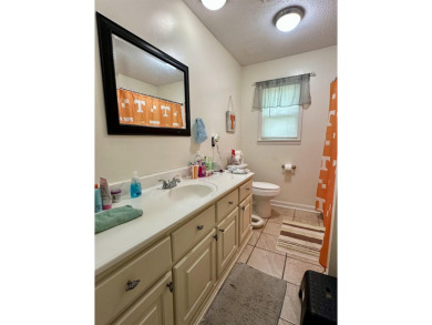 This spacious 4 (possibly 5) bedroom, 2 bathroom home is nestled on Selmer Country Club in Tennessee - for sale on GolfHomes.com, golf home, golf lot