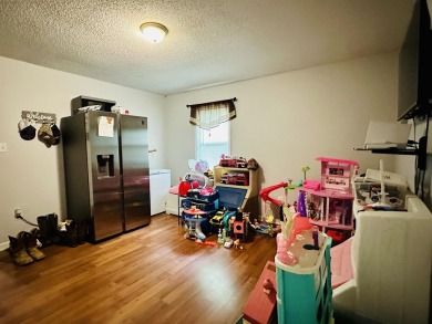 This spacious 4 (possibly 5) bedroom, 2 bathroom home is nestled on Selmer Country Club in Tennessee - for sale on GolfHomes.com, golf home, golf lot