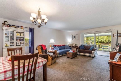 The primary bedroom boasts a mirrored closet and a sliding door on Friendly Valley Golf Course in California - for sale on GolfHomes.com, golf home, golf lot