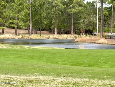 This lovely, large, wooded lot overlooks the 4th fairway and on Carolina National Golf Club in North Carolina - for sale on GolfHomes.com, golf home, golf lot