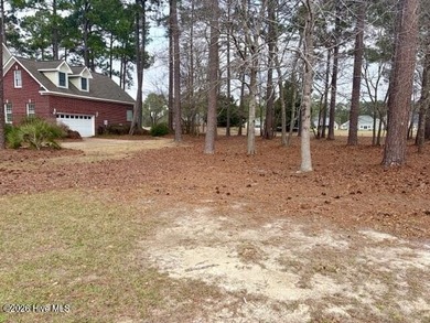 This lovely, large, wooded lot overlooks the 4th fairway and on Carolina National Golf Club in North Carolina - for sale on GolfHomes.com, golf home, golf lot