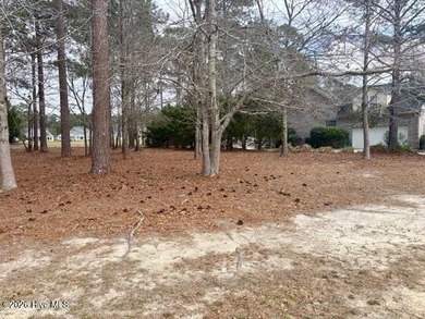 This lovely, large, wooded lot overlooks the 4th fairway and on Carolina National Golf Club in North Carolina - for sale on GolfHomes.com, golf home, golf lot