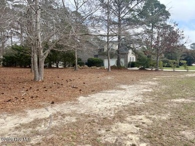 This lovely, large, wooded lot overlooks the 4th fairway and on Carolina National Golf Club in North Carolina - for sale on GolfHomes.com, golf home, golf lot