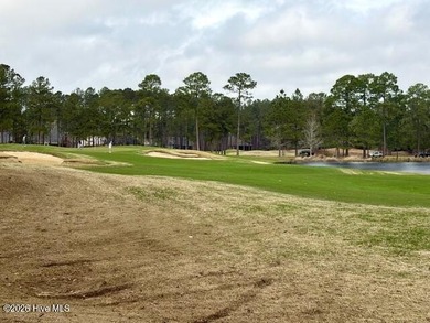 This lovely, large, wooded lot overlooks the 4th fairway and on Carolina National Golf Club in North Carolina - for sale on GolfHomes.com, golf home, golf lot