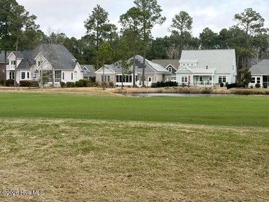 This lovely, large, wooded lot overlooks the 4th fairway and on Carolina National Golf Club in North Carolina - for sale on GolfHomes.com, golf home, golf lot