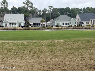 This lovely, large, wooded lot overlooks the 4th fairway and on Carolina National Golf Club in North Carolina - for sale on GolfHomes.com, golf home, golf lot