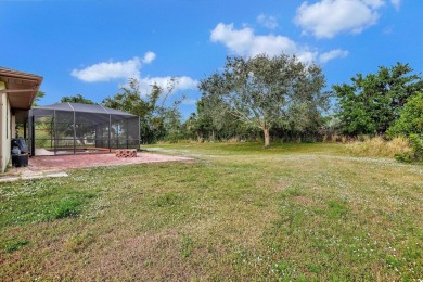 Charming pool home in Papaya Village on a rare 3/4 acre homesite on Eagle Wood Golf Course in Florida - for sale on GolfHomes.com, golf home, golf lot