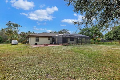 Charming pool home in Papaya Village on a rare 3/4 acre homesite on Eagle Wood Golf Course in Florida - for sale on GolfHomes.com, golf home, golf lot