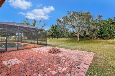 Charming pool home in Papaya Village on a rare 3/4 acre homesite on Eagle Wood Golf Course in Florida - for sale on GolfHomes.com, golf home, golf lot
