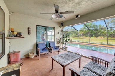 Charming pool home in Papaya Village on a rare 3/4 acre homesite on Eagle Wood Golf Course in Florida - for sale on GolfHomes.com, golf home, golf lot