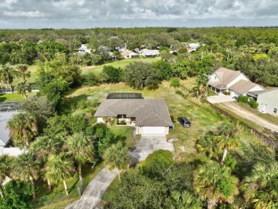 Charming pool home in Papaya Village on a rare 3/4 acre homesite on Eagle Wood Golf Course in Florida - for sale on GolfHomes.com, golf home, golf lot